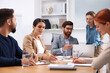 © New Africa - Team of employees working together in office
