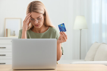 Canvas Print - Stressed woman with credit card using laptop at home, space for text. Be careful - fraud