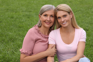 Wall Mural - Happy mature mother and her daughter outdoors