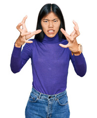 Poster - Beautiful young asian woman wearing casual clothes shouting frustrated with rage, hands trying to strangle, yelling mad