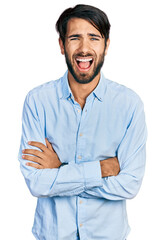 Poster - Hispanic man with blue eyes with arms crossed gesture smiling and laughing hard out loud because funny crazy joke.