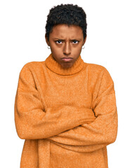 Wall Mural - Young african american woman wearing casual clothes skeptic and nervous, disapproving expression on face with crossed arms. negative person.