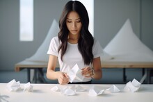 Asian Woman Making An Origami Figurine. White Paper Craft In Japanese Style. Hobby.