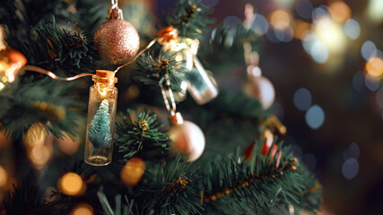 Wall Mural - closeup - elegant christmas tree in glass jar with bokeh lights on christmas tree, christmas and new