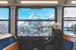 © oatawa - Happy Tourist woman looking out the window enjoying with the snow Matterhorn mountain while sitting in the train, Zermatt in Switzerland.