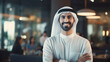 Portrait of happy Young Arab businessman looks in camera at office background.