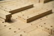 Close up of wooden parts in in big furniture manufacturing facility. Wooden parts for the production of chairs in the warehouse of a furniture factory.