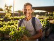 © zamuruev - farmer holding fresh leaf vegetable in farm, smiling, close-up, portrait. agricultural business