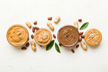 Wall Mural - Glass jar with peanut butter on table background, top view space for text and close up