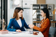 © Nuttapong punna - Consultation between a female lawyer and business customer, handshake after good deal agreement, Law and Legal concept.