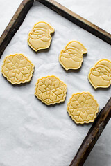 Sticker - Top view of cut out raw sugar cookie dough for christmas, Christmas sugar cookie dough about to be baked, process of making xmas sugar cookies