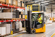 © Halfpoint - Warehouse worker driving forklift. Warehouse worker preparing products for shipmennt, delivery, checking stock in warehouse, order picking.