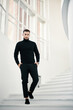© GVS - Confident fashionable man descending white modern staircase