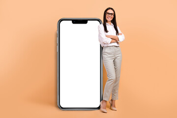 Canvas Print - Full size photo of attractive successful girl crossed arms large empty space smart phone isolated on beige color background