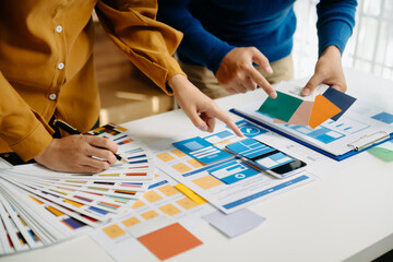  UX developer and ui designer brainstorming about mobile app interface wireframe design with customer breif and color code