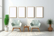 Living room with armchair in Scandinavian interior design with four empty wooden photo frames on light wall. Mock up template copy space for text