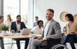 © radekcho - Businessman in wheelchair having business meeting with team at office. A group of young freelancers agree on new online business projects. Person in a wheelchair leading a meeting in a conference room