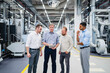 © Westend61 - Businessman sharing digital tablet with staff in a factory