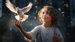 Boy with beautiful curly hair releases a white dove from his hands against the backdrop of a fairytale forest and flying butterflies and leaves.