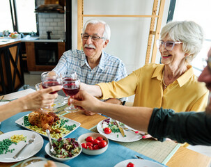 senior mature elderly couple active family lunch food woman meal eating mother dinner father grandfather grandmother home table parent grandparent