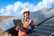 © bulentbaris - Young engineer inspect installation of solar panels installed check  with blueprint on the field, with recording inspection data on pc.