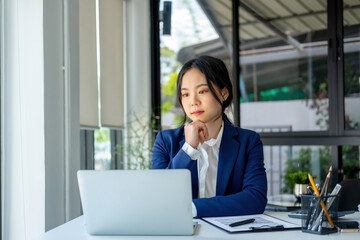 Busineswoman working by using laptop.