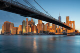 Fototapeta  - Classic view of Manhattan under Brooklyn Bridge at sunrise