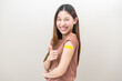 Healthcare of Covid-19, corona anti virus vaccination, happy asian young woman hand showing like at bandage, plaster on arm, getting vaccine immunity giving injection influenza to protection pandemic.