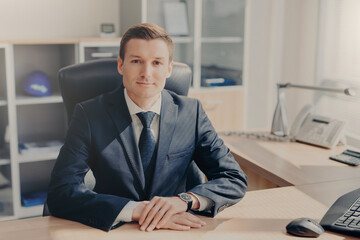 Confident businessman at desk in a sleek office