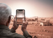 Back view Elderly man take photo with mobile phone with copy space.