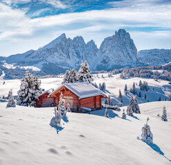 Wall Mural - snowy winter scene of alpe di siusi village with plattkofel peak on background. untouched morning vi