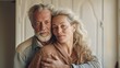 © Z A C - Loving middle-aged couple embraces at home.