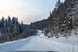 Fototapeta Na ścianę - Winter landscape, road through a snowy forest. Winter travel.
