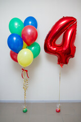 balloon red number 4 and a bunch of multi-colored balloons