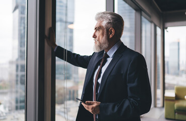 Sticker - Pensive male entrepreneur looking out of window