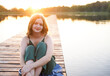 © Iryna - Beautiful cute teen girl relaxing at the lake or river in sunset in summer.