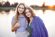 © Iryna - Summer portrait of two teenagers girl friends on wooden bridge at nature outdoors.