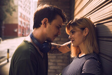 Young Couple In Love Face To Face Embracing On City Street