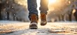 Winter holiday background - Closeup of man with jeans and boots walking in snow, snowscape snowy landscape with snowflakes and sunshine