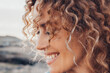 Close up side view portrait of happy woman with serene expression smiling and enjoying life outdoor leisure activity alone. Adult caucasian female people happy thoughts and enjoying life in outdoors