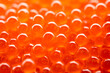Closeup of natural red caviar as background, texture of expensive luxury fresh orange caviar macro photo
