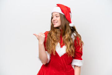 Wall Mural - Young caucasian woman with Christmas dress isolated on white background pointing to the side to present a product