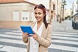 © Krakenimages.com - Young caucasian woman business worker using touchpad at street