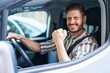 © Krakenimages.com - Hispanic man with beard driving car screaming proud, celebrating victory and success very excited with raised arm