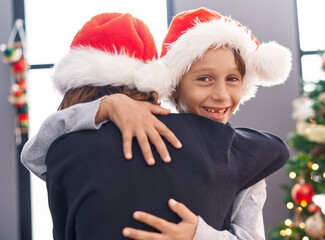 Poster - Adorable boys hugging each other celebrating christmas at home