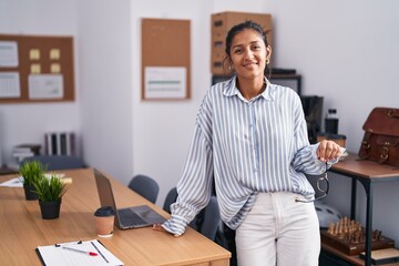 Canvas Print - Young beautiful hispanic woman business worker smiling confident holding glasses at office