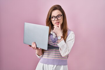 Canvas Print - Young caucasian woman working using computer laptop thinking worried about a question, concerned and nervous with hand on chin