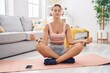 © Krakenimages.com - Young blonde woman doing yoga exercise sitting on floor at home