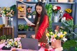 © Krakenimages.com - Young chinese woman florist using laptop reading document at flower shop