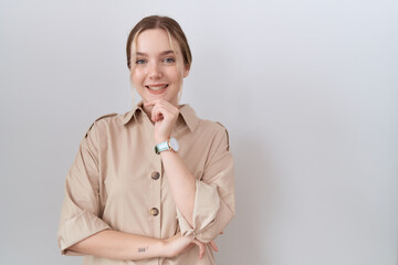 Wall Mural - Young caucasian woman wearing casual shirt looking confident at the camera smiling with crossed arms and hand raised on chin. thinking positive.